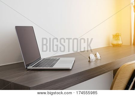 office table white laptop modern chair and modern eyeglasses. concept of business lifestyle. view from side office table.