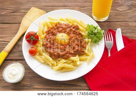 Penne Pasta In Tomato Sauce On A Wooden Background