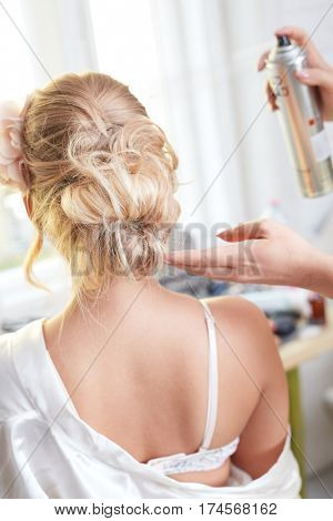 Closeup photo of bridal knot fixed by hairspray.
