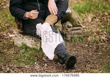 Re-enactor Dressed As Russian Soviet Crew Member Soldier Of World War II Puts on Foot Wraps.