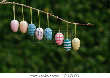 Easter eggs border on natural green background in natural light