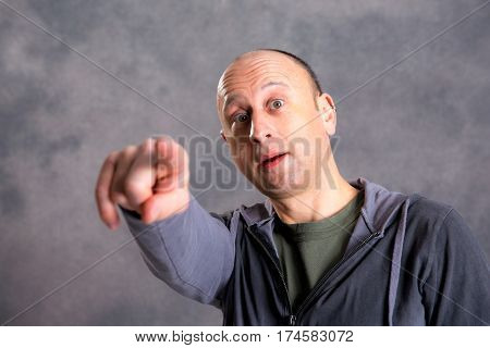 Baldheaded Man Pointing In To The Camera