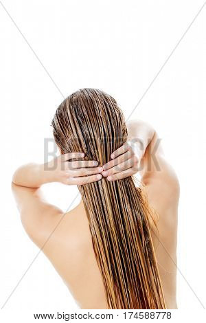 Photo of woman applying hair conditioner.