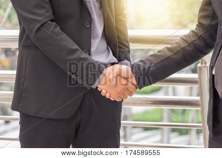 Success and Happiness concept Business man handshake at city outside office.