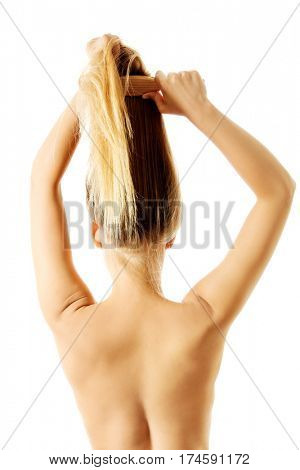 Photo of combing woman with long blond hair