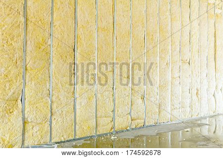 Galvanized steel joist is holding thermal insulation material rock wool.