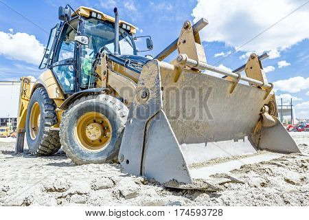 Close up view of excavator's undercarriage on construction site.