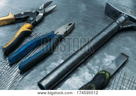 Top view of set working tools lying on metal table industry
