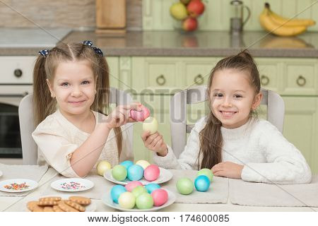 Cute smiling kids holding painted easter eggs.
