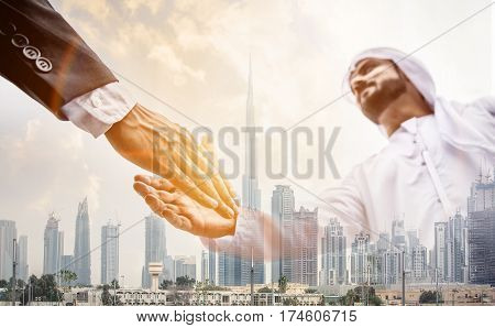 Double exposure with business team over dubai skyline