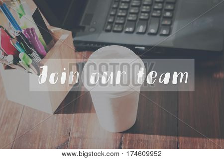 Concept join our team message on the device works the table background