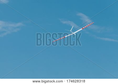 RC remotely controlled soaring plane model sailplane on blue sky in brisk wind