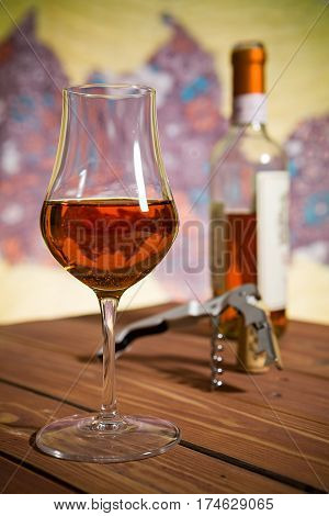 Closeup of a glass of Italian vin santo wine on a wooden table