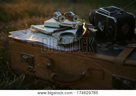 vintage pearl operaglasses, camera and notepads in the sunset light