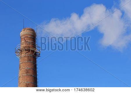 Smoke from pipe on a background of clear sky