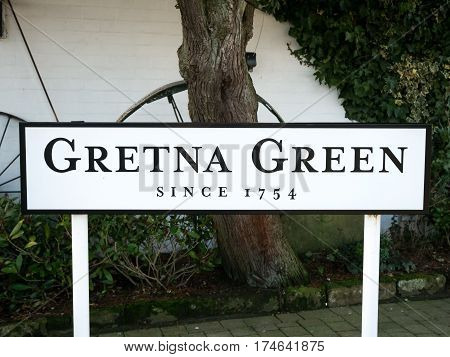 Place name sign at the Gretna Green blacksmith, the place in Scotland where eloped couples get married over the blacksmith anvil