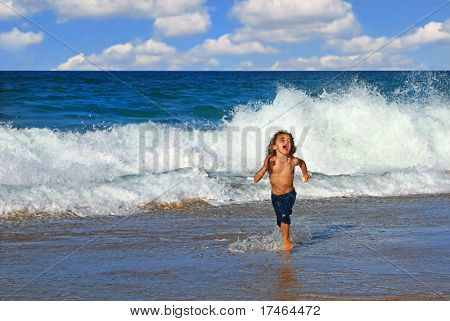 Young Happy Boy Running in the Ocean Surf
