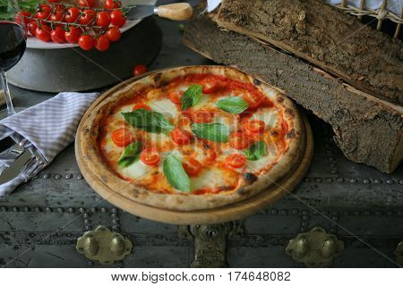 Neapolitan pizza with mozzarella, cherry tomato and fresh basil