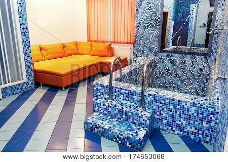 Luxury Whirlpool Bathtub In Elegant Recreation Room In Rehabilitation Center, Blue Tile Flooring, Re