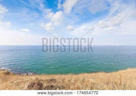 Beautiful seascape with rocks and meadow in cloudy blue sky at Khao Leam Ya National Park Rayong province Thailand
