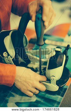 Snowboard Repair Shop Worker Adjust The Bindings