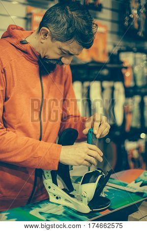 Snowboard Repair Shop Worker Adjust The Bindings