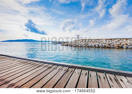 Wooden plank pier with seascape and bright blue sky for relax time at Khao Leam Ya National Park Rayong Province Thailand