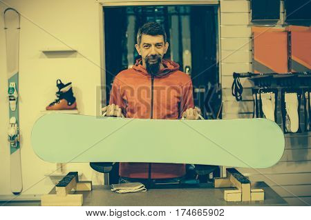 Snowboard Repair Shop Worker Adjust The Bindings