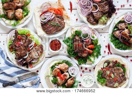 Assortment of grilled meat meals flat lay. Top view on restaurant table with variety of barbecue snacks. Restaurant menu, delicious food, dieting, gourmet concept