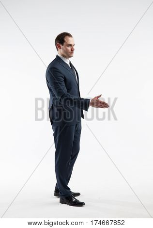 Portrait of a mature businessman in a suit make a deal isolated on white background