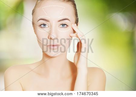 beautiful young woman face with lifting marks for surgeon