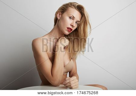 Portrait of beautiful young woman with blonde hair wearing red lipstick.