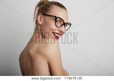 Portrait of beautiful smiling young woman. Wearing glasses