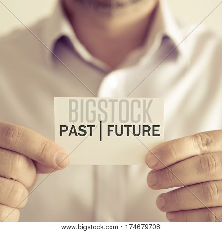 Businessman Holding Past Future Message Card