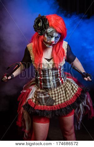 Theatrical lighting, special effects, and a custom makeup bring this evil clown to life. This is her circus now