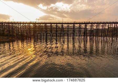 old an long wooden bridge with sunset light at SangklaburiKanchanaburi province Thailand