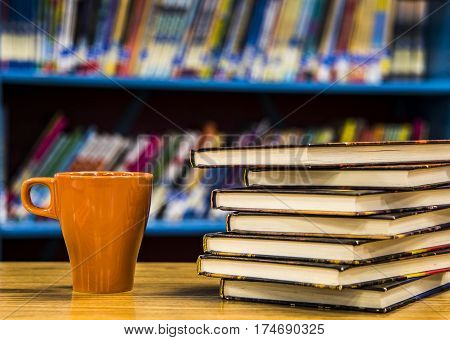 books on the table in the library, old books on table with blurry background of bookshelves, university bookstore, Stack Of Old Books in the library, Stacked Books, library concept,