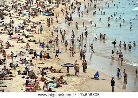 Sydney Australia - Feb 5 2017. People relaxing swimming and sun bathing on Bondi beach. Bondi beach is one of the most famous tourist sites in Australia.