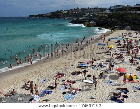 Sydney Australia - Feb 5 2017. People relaxing swimming and sun bathing on Tamarama beach.