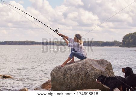 woman fisher sitting on summer sea beach