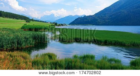 Beautiful view of the lake Muta (Haidersee) and Ortler peak, located near the village St. Valentin, Alps, Italy, Europe.