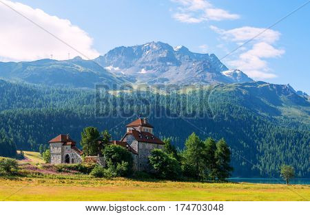Amazing sunny day at Champferersee lake in the Swiss Alps. Castle of Crap da Sass, Silvaplana village, Switzerland, Europe.