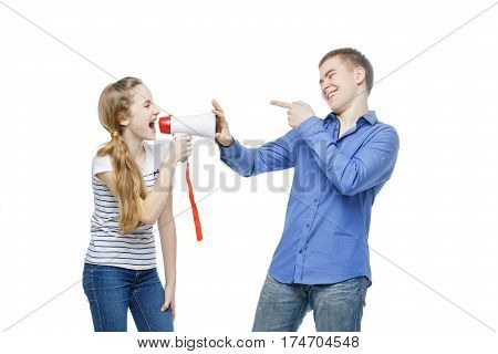 Teen age girl screaming at boy through megaphone. Brother and sister isolated on white background. Copy space.