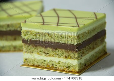 A pistacho layer cake and chocolate garnache