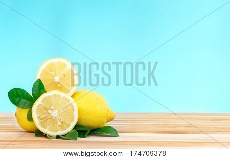 fresh lemons gruop on wooden table with blue backgrond