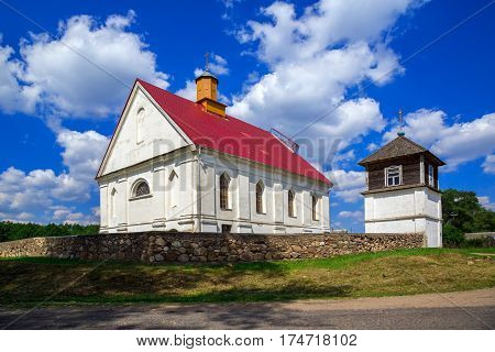 Church of the Assumption of the Blessed Virgin Mary on a background of blue sky with clouds old architecture religious places Belarus Village Pleban Molodechno District