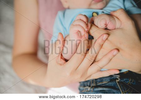 father and mother hold in their hands a little newborn baby's