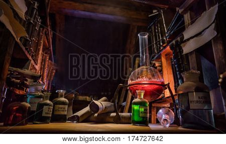 Medieval alchemist laboratory with various kind of flasks and old books in Prague, czech republic