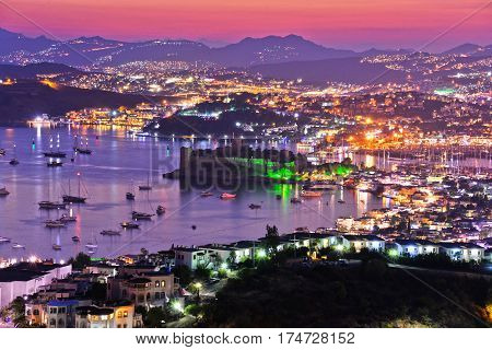 View of Bodrum harbor and Castle of St. Peter by night. Turkish Riviera.