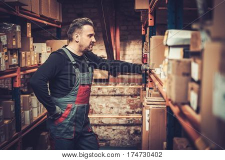 Storekeeper near shelves on a warehouse